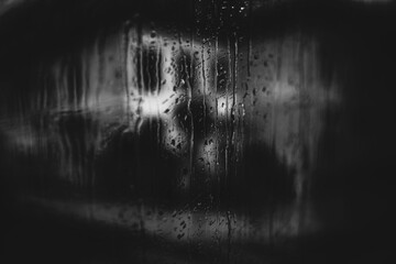 rain on the window. Black and white toned image 