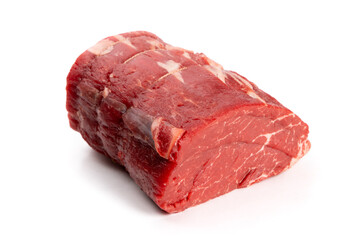 A center cut piece of beef tenderloin with trussing strings isolated on white