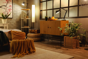 Interior of modern bedroom wooden cabinet and glowing lamps at night