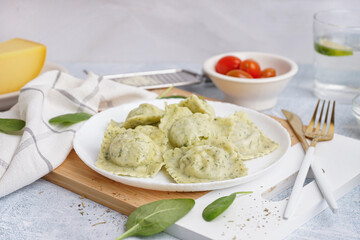 Plate of tasty ravioli on white background