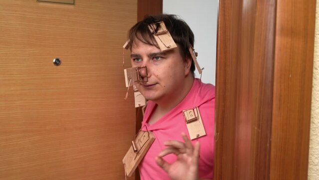 Loser father raising children, victim of prank, opens door, enraged holds back emotion, hand gesture ok, everything is fine Open door to curious neighbors, family fun, children prank Parental patience