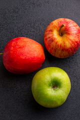 delicious and healthy apples on a pallet on a wooden table, bitten apple, red apple and green apple