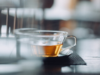 Hot tea in glass cup with foreground blur