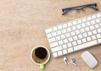 Top view with mini wireless keyboard and mouse with coffee and glasses on wood table.