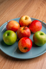 delicious apples on a wooden table, bitten apple, red apple and green apple