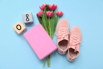 Composition with sports equipment, shoes and tulip flowers for International Women's Day