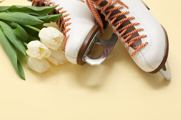 Pair of ice skates and tulip flowers for International Women's Day on color background, closeup