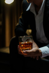businessmen holding a glass of whiskey