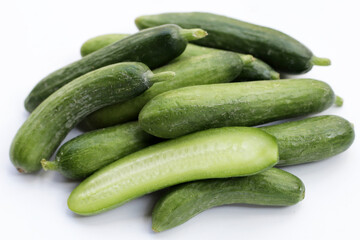 Mini cucumbers on white background.