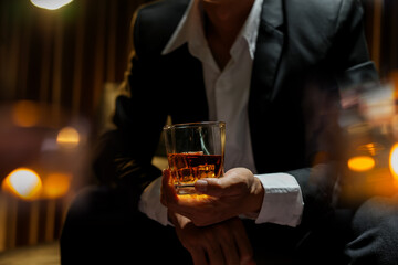 businessmen holding a glass of whiskey