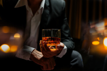 businessmen holding a glass of whiskey