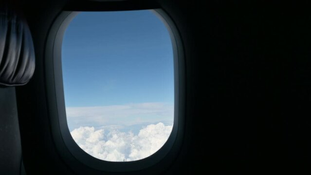 airplane flight flying trip travel above clear blue sky with beautiful cloud, looking at view through window of plane