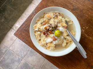 Bubur Sapi Pontianak or Beef Porridge is Indonesian traditional food consist of white rice porridge, ground beef, fried peanut, crackers, calamansi and egg.