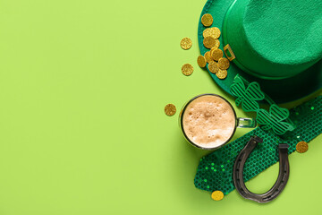 Mug of dark beer with leprechaun hat, plastic eyeglasses and horseshoe on green background. St....