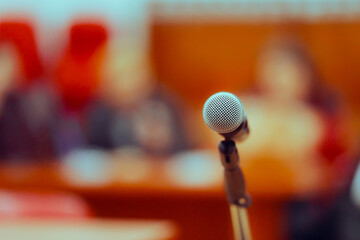 Microphone in front of an Audience at a Press Conference Event. Press Conference Microphone in a Meeting Room
