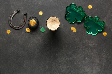Glass of dark beer with plastic eyeglasses, horseshoe and pot of golden coins for St. Patrick's Day celebration on black grunge background - obrazy, fototapety, plakaty