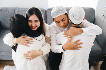 Parents and children hugging and forgive each other at Eid mubarak moment. Islamic culture and...