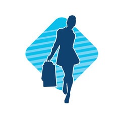 Silhouette of a slim young woman carrying shopping bags.