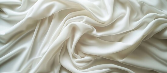 Obraz premium A detailed shot of a white fabric featuring elegant wave patterns, showcasing the intricate artistry and craftsmanship of the design.
