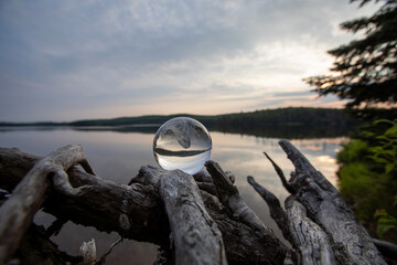 Using a crystal lens ball to capture the moments after golden hour at sunset in a provincial park in Ontario. - obrazy, fototapety, plakaty