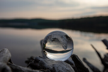 Using a crystal lens ball to capture the moments after golden hour at sunset in a provincial park in Ontario. - obrazy, fototapety, plakaty