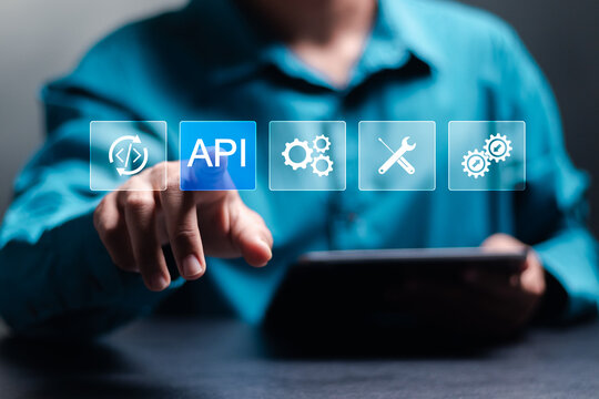 API, Application programing interface concept, software development tool, information technology. Businessman touching API icon on virtual screen. - Powered by Adobe