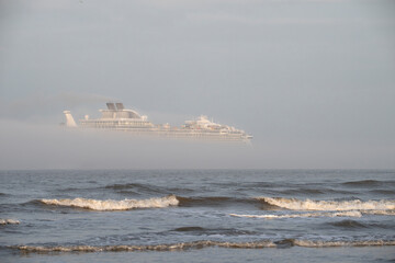 Fototapeta na wymiar Cruise Ship Leaving Port Of Galveston in a stripe of the dense fog