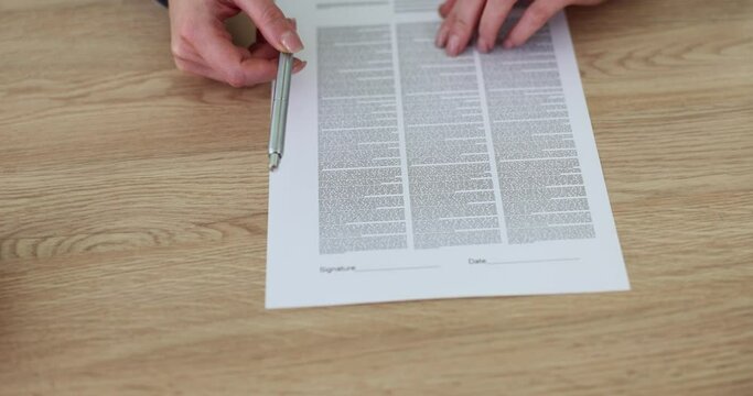 Female agent offers to sign document at table