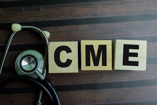 Concept of The wooden Cubes with the word CME on wooden background.