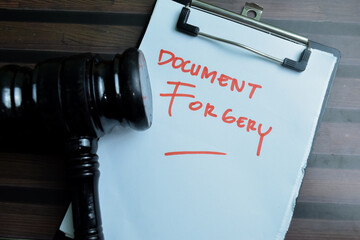 Concept of Document Forgery write on paperwork isolated on wooden background. - obrazy, fototapety, plakaty