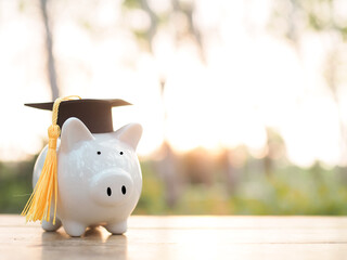 Piggy bank with graduation hat. The concept of saving money for education, student loan, scholarship, tuition fees in future