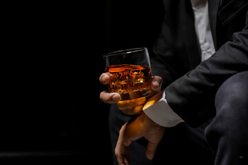 Closeup businessmen holding a glass of whiskey