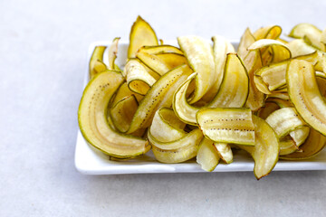 Banana chips, fried slices banana with green peel