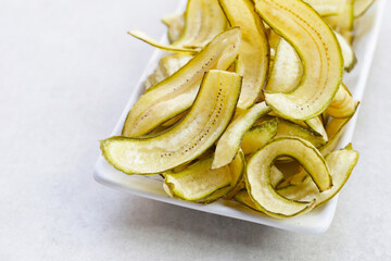 Banana chips, fried slices banana with green peel