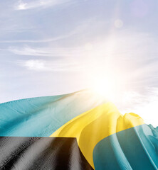 The Bahamas flag in waving in beautiful sky with sunlight.