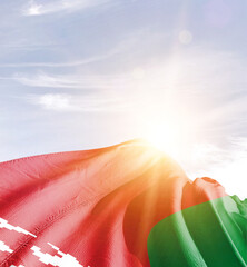 Belarus flag in waving in beautiful sky with sunlight.