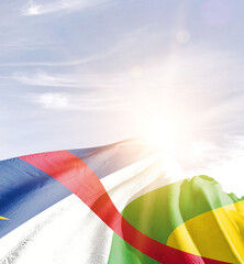 Central African Republic flag in waving in beautiful sky with sunlight.