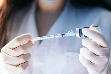 injecting injection vaccine vaccination medicine against coronavirus woman doctor