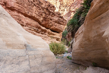 Bizarre grandeur of mountains in path of shallow stream in gorge Wadi Al Ghuwayr or An Nakhil and the wadi Al Dathneh near Amman in Jordan