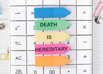 DEATH IS HEREDITARY text written on arrow-shaped stickers