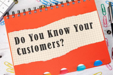 Do You Know Your Customer text on a piece of paper in a cage on the background of an orange...