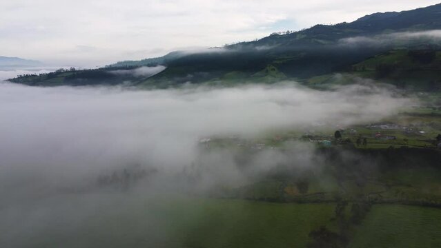 Cinematic parallel drone over the clous aerial clip over misty fields in Neblina, Machachi, Equador