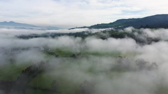 Cinematic slow aerial drone flying through the clouds over the mountains in Neblina, Machachi, Equador
