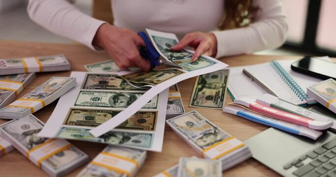 Woman cuts money with scissors. concept