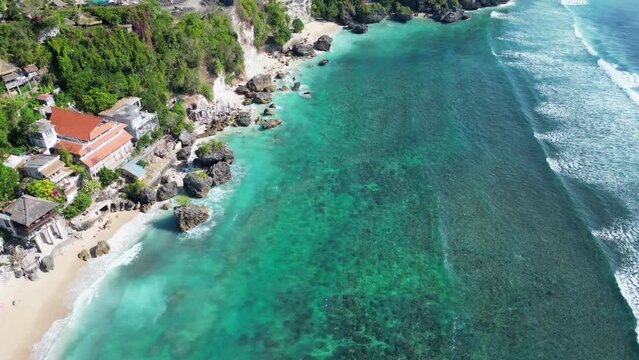 Azure Blue Water Laps Against Bingin Beach In Bali Indonesia