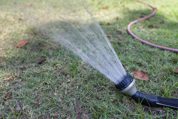 Classic water sprayer in sunshine day.