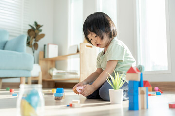 Happy Asian child playing and learning toy blocks. children are very happy and excited at home....