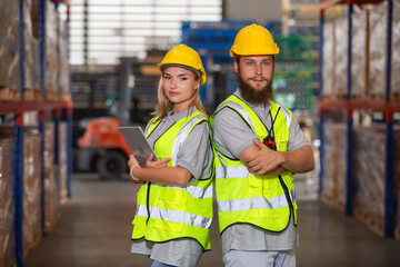 Male and Female professional worker wearing safety uniform using tablet inspect goods on shelves in warehouse. supervisor worker checklist stock inspecting product in storage for logistic.
