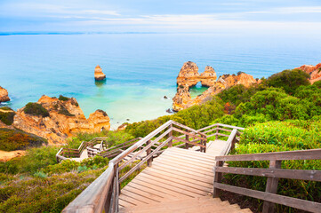 Rocks on the shore of Atlantic ocean in Algarve, Portugal. Stairs to the beach.