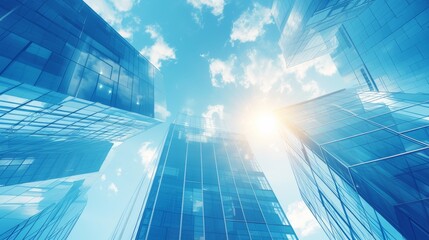 Modern office building with blue sky, and glass facades. Economy, finances, business activity concept, Bottom-up view, blurred image